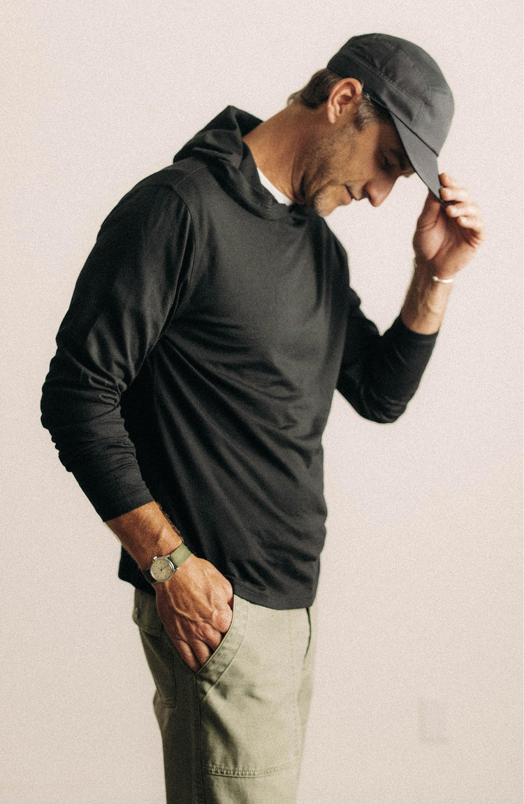 fit model posing in The Ridgeline Merino Hoodie in Coal