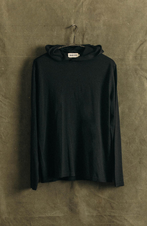 editorial image of The Ridgeline Merino Hoodie in Coal hanging