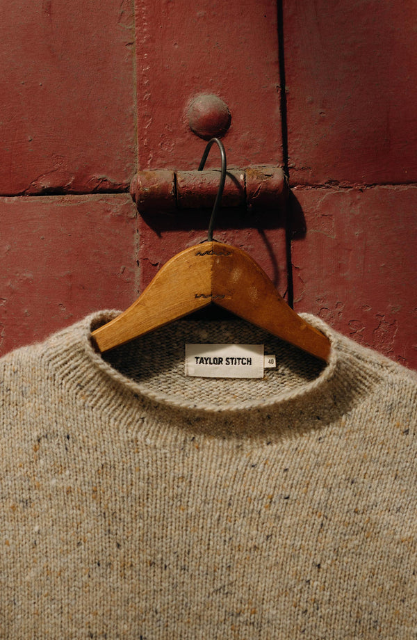 editorial image of The Seafarer Sweater in Natural Donegal on a hanger