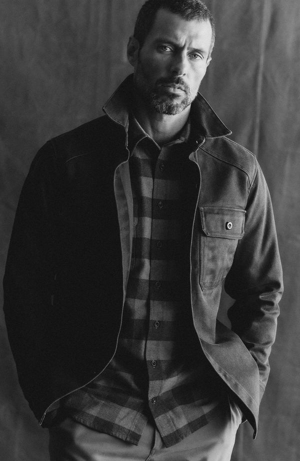 fit model sitting wearing The Shop Shirt in Coal Chipped Canvas