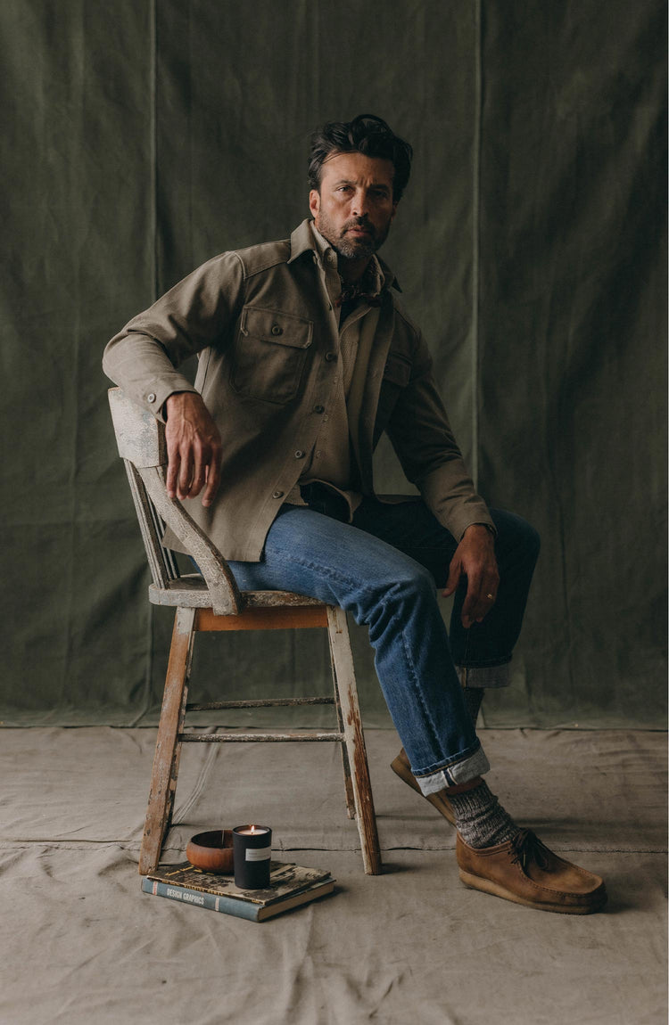 fit model holding a bag wearing The Shop Shirt in Stone Chipped Canvas