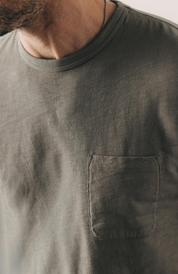 fit model showing off the pocket on The Slub Tee in Smoked Olive