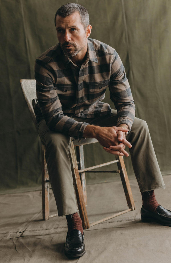 fit model sitting wearing The Yosemite Shirt in Heather Sable Buffalo Check