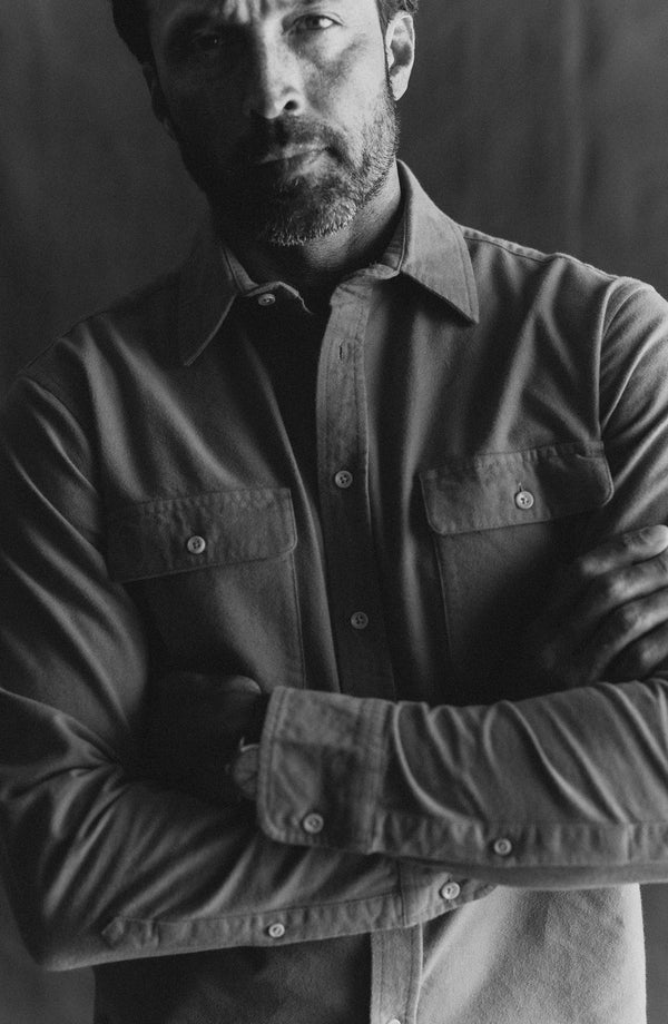 fit model with his arms folded wearing The Yosemite Shirt in Summit Orange