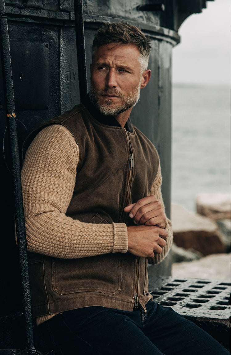 fit model adjusting his sleeves wearing The Workhorse Vest in Aged Penny Chipped Canvas