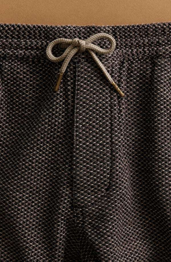 editorial image of The Apres Pant in Charcoal Sashiko hanging