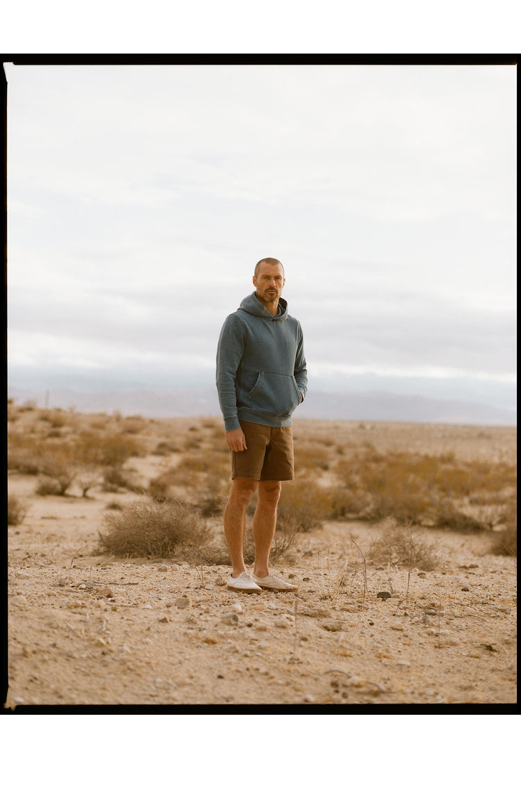 fit model posing wearing The Apres Hoodie in Washed Indigo Terry