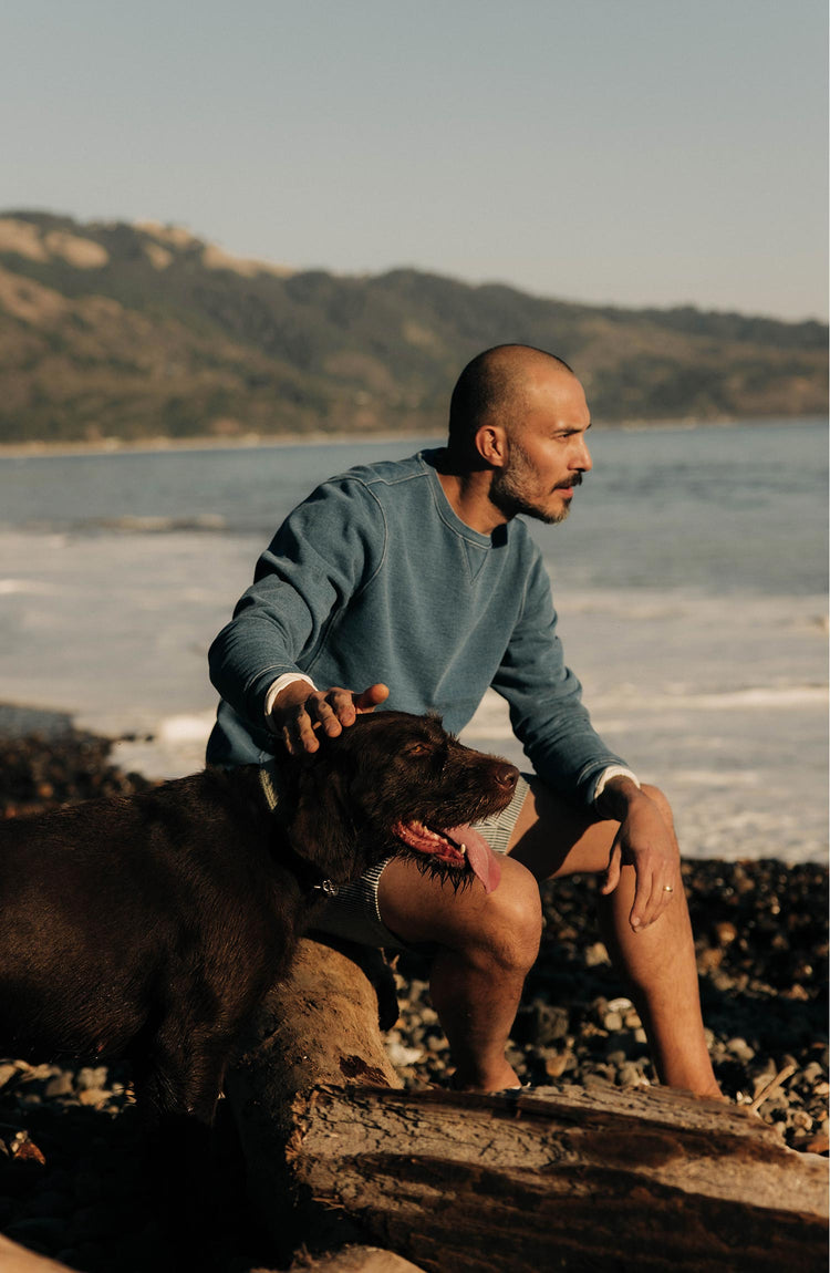 fit model patting a dog wearing The Apres Crew in Washed Indigo Terry