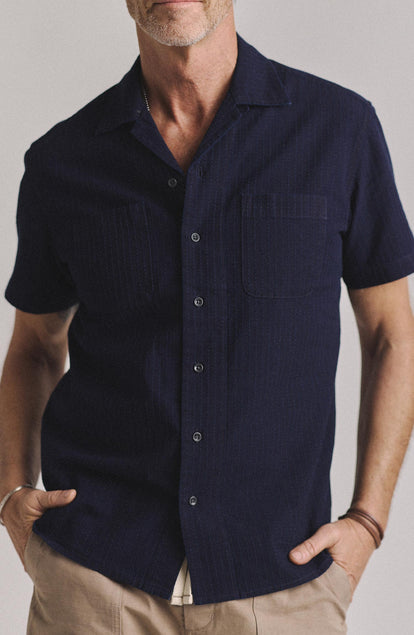 fit model with his hands in his pockets wearing The Conrad Shirt in Rinsed Indigo Pickstitch