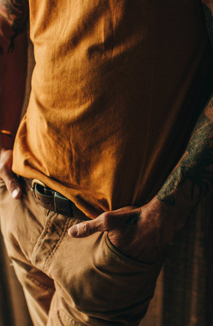 Close up of model wearing shirt with hands in pockets