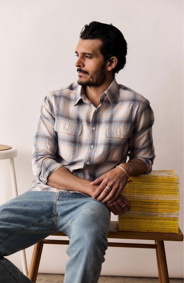fit model sitting wearing The Craftsman Shirt in Sky Shadow Plaid
