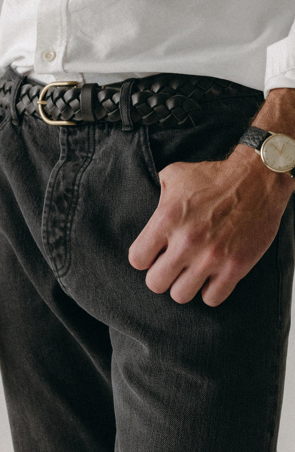 fit model with his hand in his pocket wearing The Democratic Jean in Washed Black Organic Slub Selvedge