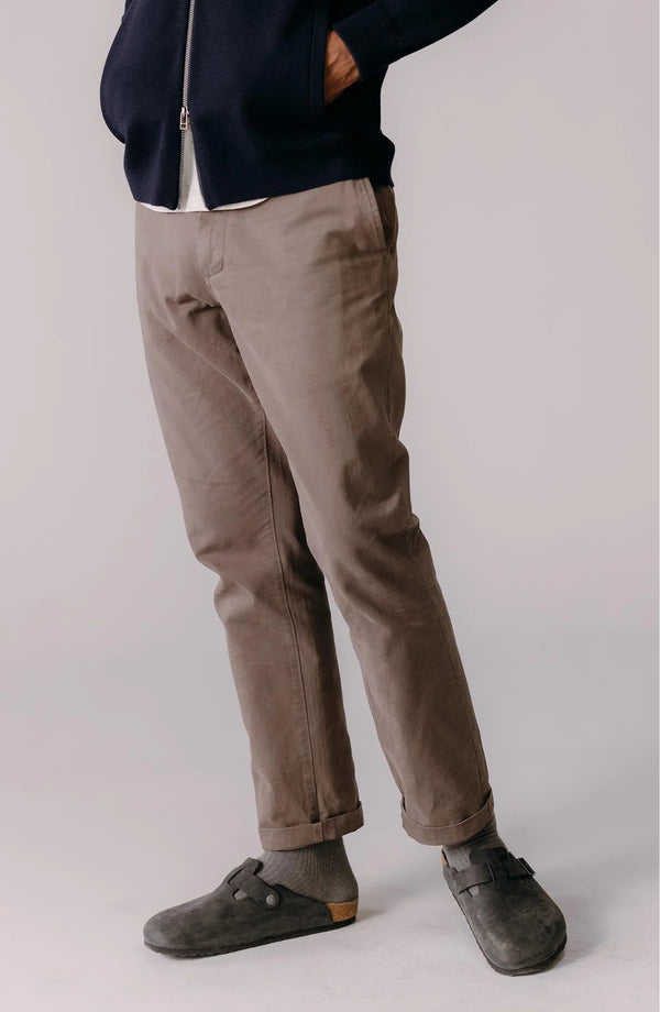 A pair of Foundation Pants folded on a black background.
