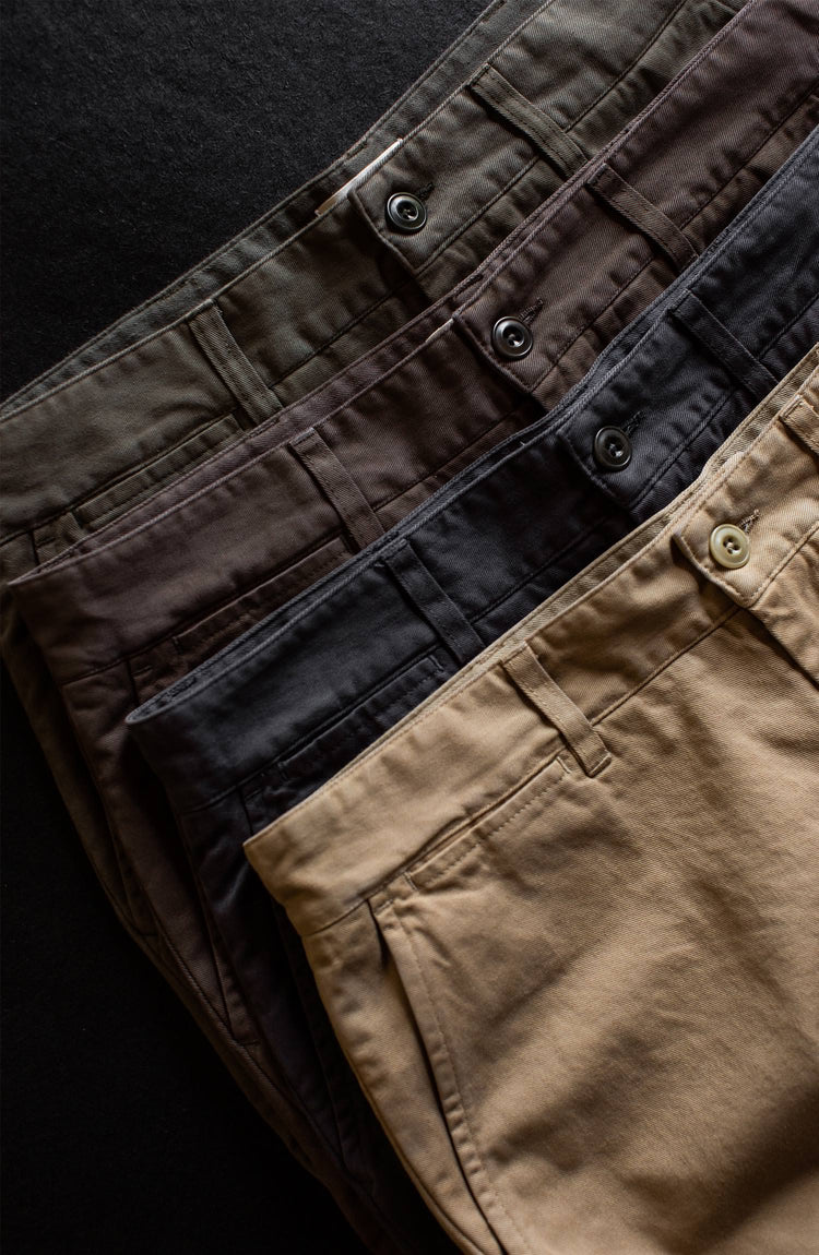 Flatlay shot on a black background showing the waistbands of our Foundation Pant lineup, arranged diagonally.