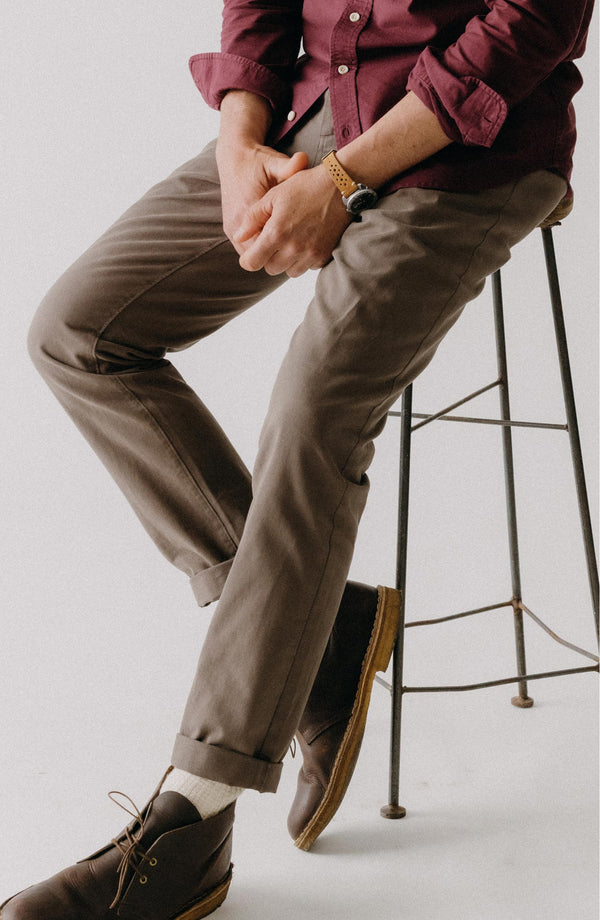 A pair of Foundation Pants folded on a black background.
