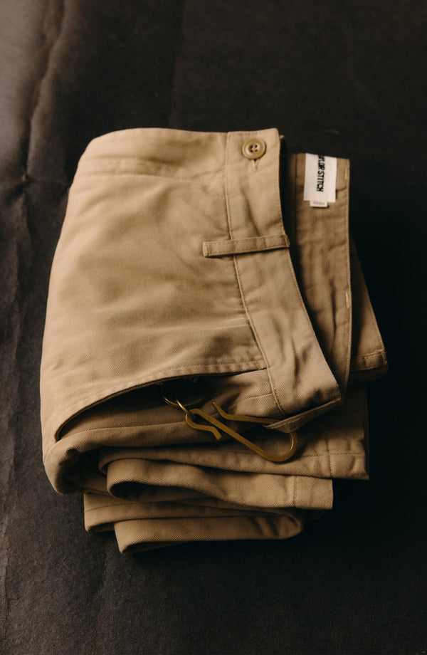 A pair of Foundation Pants folded on a black background.