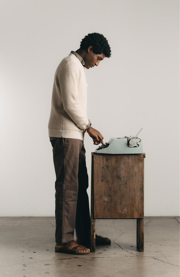 A pair of Foundation Pants folded on a black background.