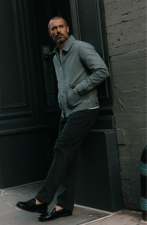 A pair of Foundation Pants folded on a black background.