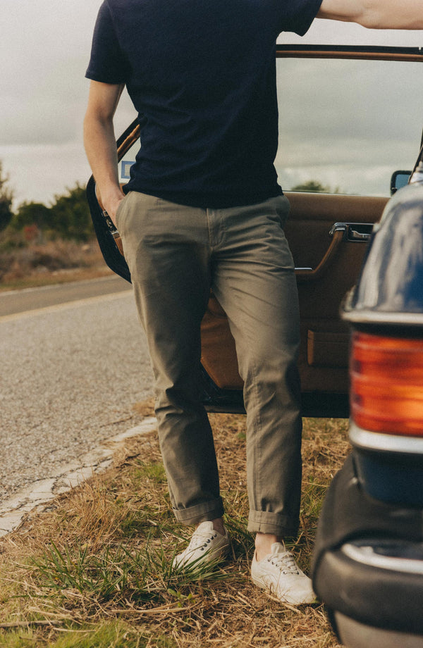 A pair of Foundation Pants folded on a black background, showing the back pocket.