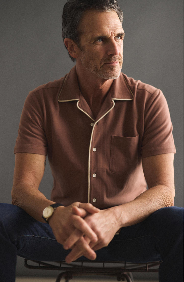 fit model sitting wearing The Harwich Shirt in Faded Brick Tipped Pique