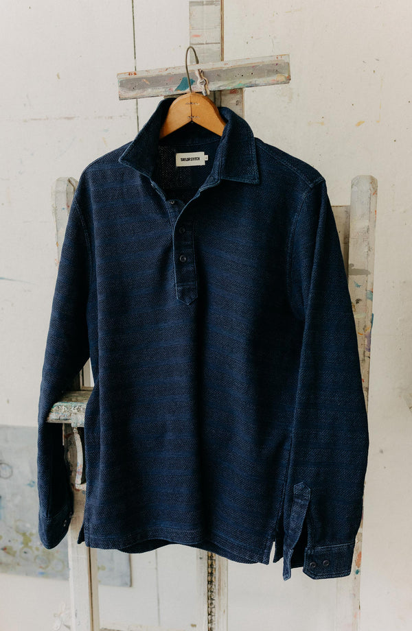 editorial image of The Long Sleeve Polo in Indigo Knit Stripe hanging