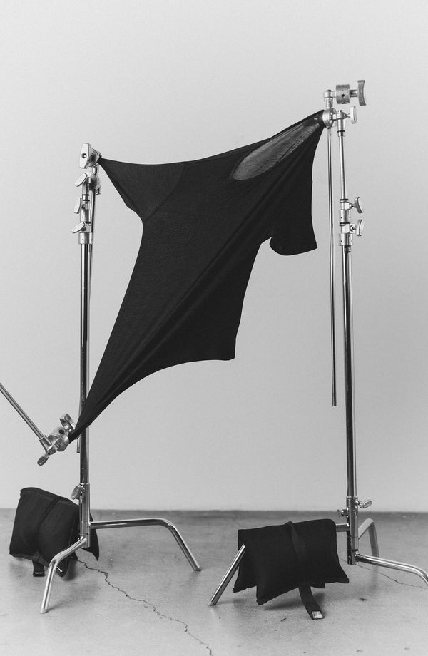 our guy rocking the merino tee near the beach—split shot