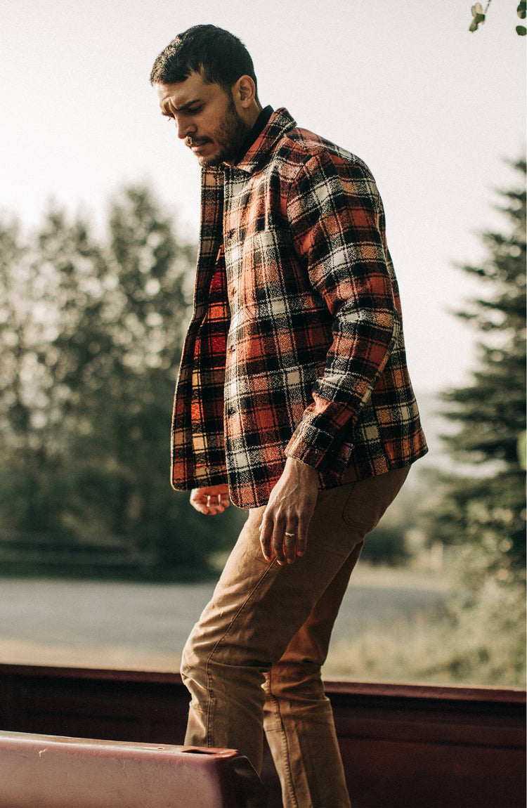 Our guy wearing The Ojai Jacket in Garnet Plaid Wool in the flatbed of a truck