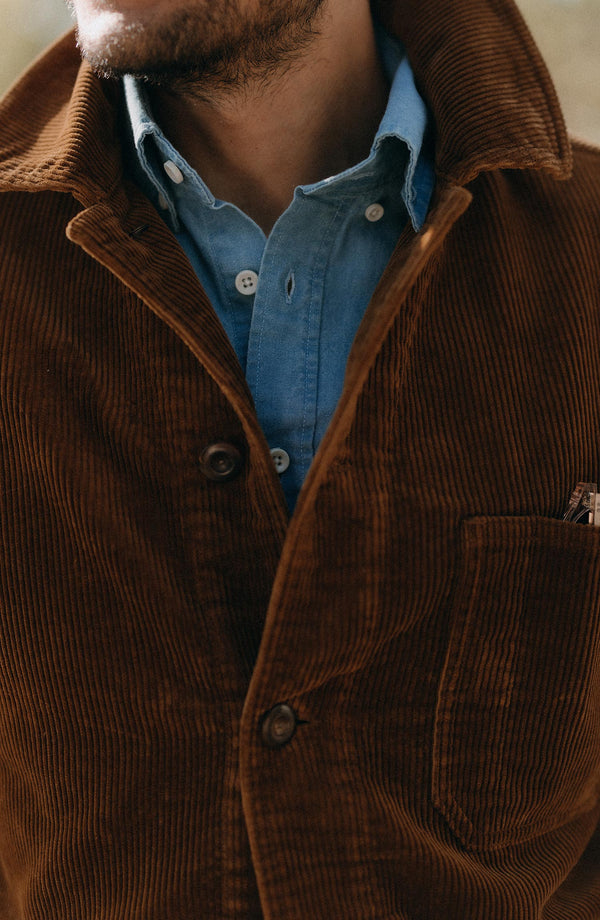 fit model sitting in a seaplane wearing The Ojai Jacket in Bourbon Corduroy