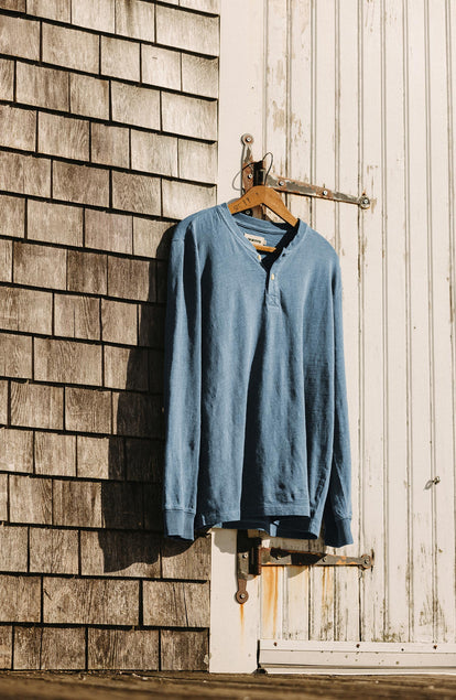 editorial image of The Organic Cotton Henley in Washed Indigo on a hanger