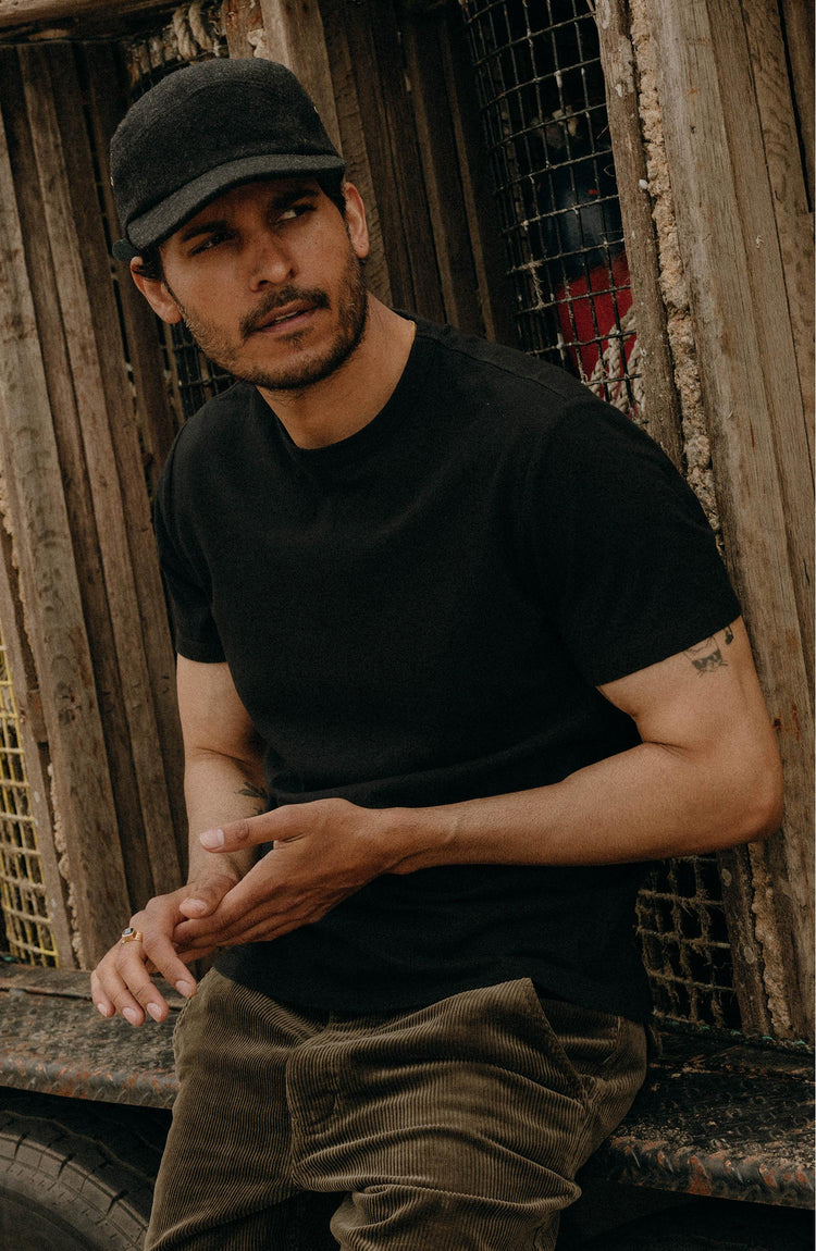 fit model sitting wearing The Organic Cotton Tee in Black