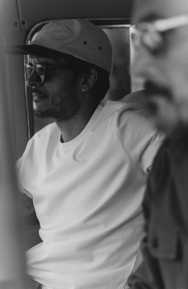 fit model sitting wearing The Organic Cotton Tee in White