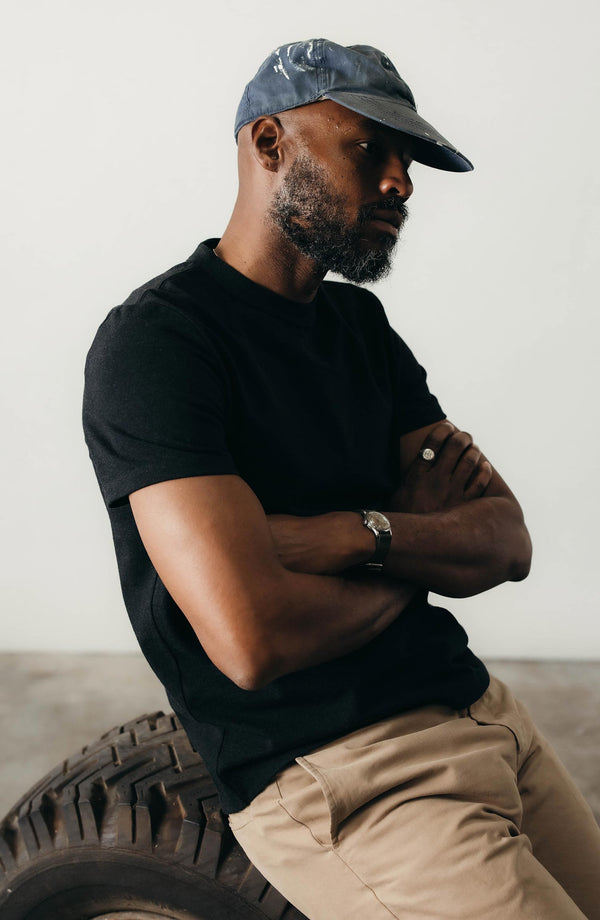 fit model sitting wearing The Organic Cotton Shop Tee in Coal Twist