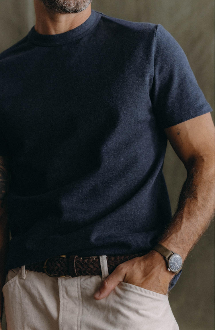 fit model throwing a rock wearing The Organic Cotton Shop Tee in Navy Twist