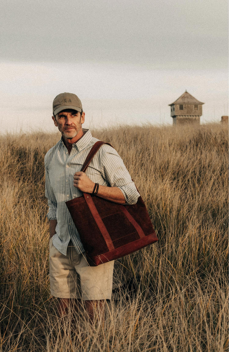 fit model walking carrying The Roughout Tote in Chocolate Suede