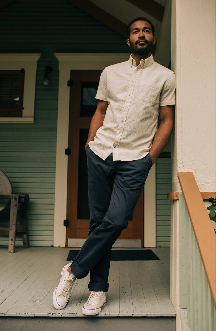 Model wearing The Short Sleeve Jack in Natural Seersucker on a porch”