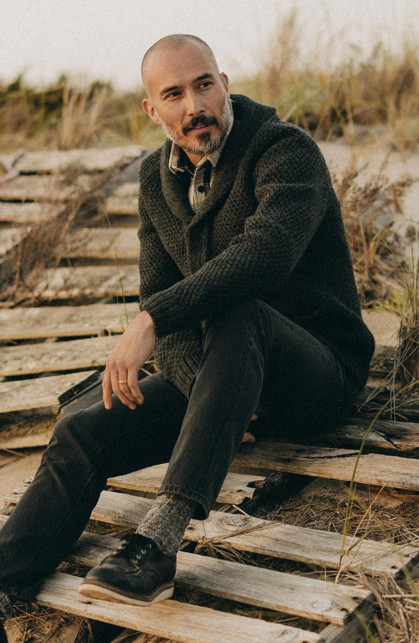 fit model sitting wearing The Slim Jean in Washed Black Organic Slub Selvedge