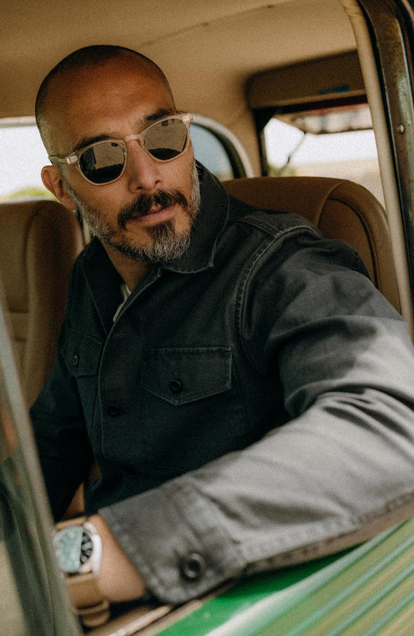 fit model sitting wearing The Surplus Shirt in Faded Black Reverse Sateen