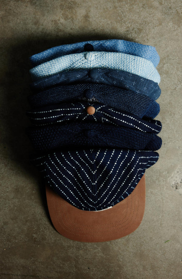 An assortment of Hypeadelic for Taylor Stitch caps