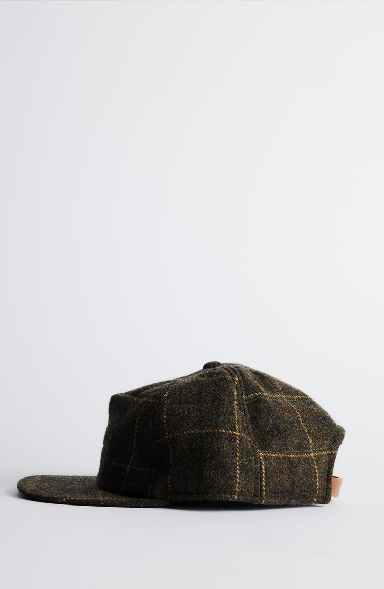 Close up of an olive plaid Hypeadelic for Taylor Stitch cap