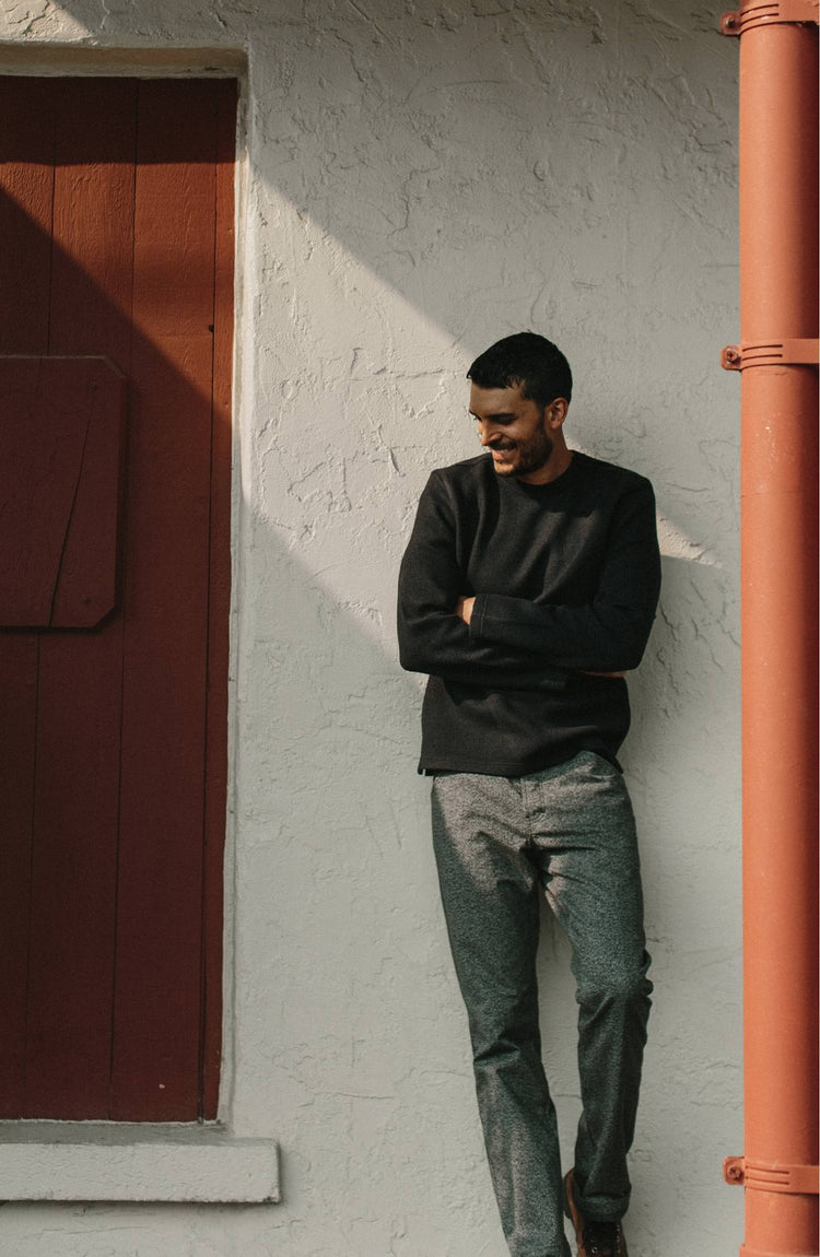 Model wearing The Weekend Crewneck in Navy Boiled Wool with his arms crossed