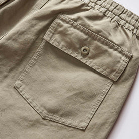 material shot of the back pocket on The Apres Trail Short in Light Sage Slub