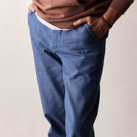 fit model with his hands in the pockets of The Morse Pant in Bleached Indigo Herringbone