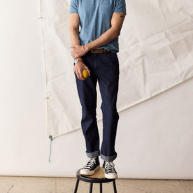 fit model standing on a stool in The Morse Pant in Rinsed Indigo Stripe