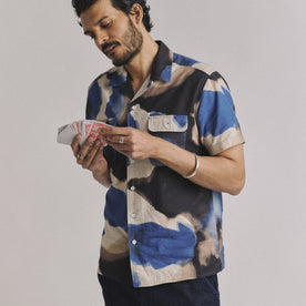 fit model playing with cards wearing The Short Sleeve Carter in Dark Navy Abstract
