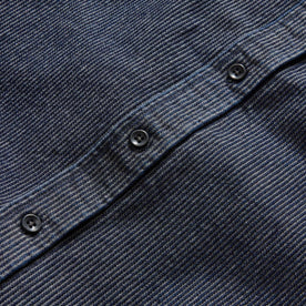 material shot of the charcoal buttons on The Utility Shirt in Rinsed Indigo Stripe