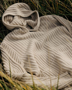 material shot of The Bryan Pullover Sweater in Flax Melange in the grass, Knits by Taylor Stitch