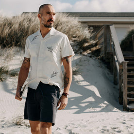 fit model walking on the beach wearing The Conrad Shirt in Seaside Embroidery