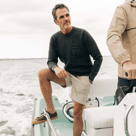 fit model on a boat in The Crawford Crew Sweater in Washed Asphalt