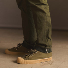 fit model showing off selvage cuffs on The Democratic Jean in Olive Nihon Menpu Selvage