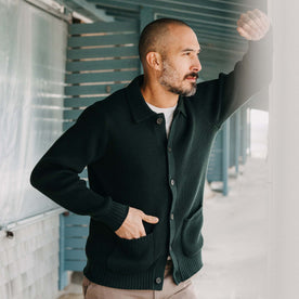 fit model with his hand in the front pockets of The Harbor Sweater Jacket in Black Pine Heather
